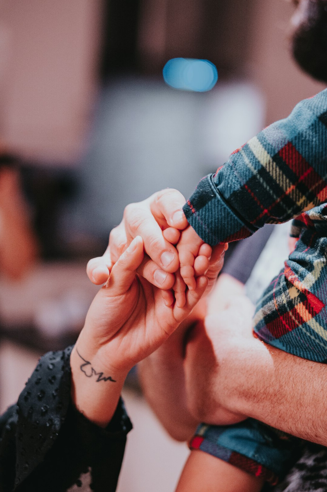Colleagues stacking hands together in teamwork